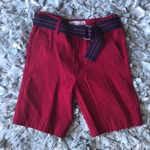 Boys red shorts with navy belt.